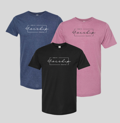 Three t-shirts in blue, black, and pink with 'Made to Worship' text on a gray background